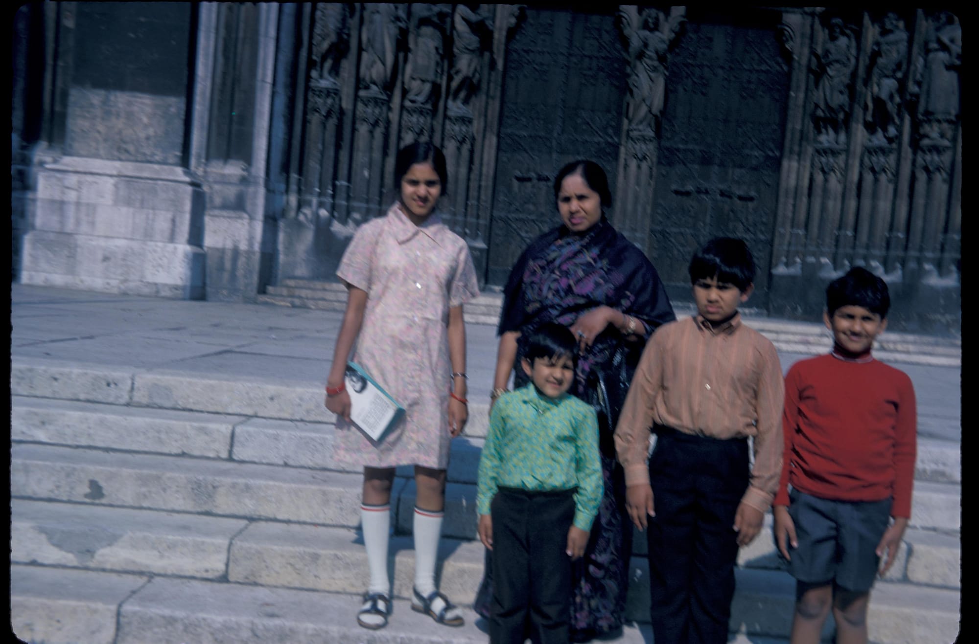 Mataji and all the children. A Gothic cathedral in Europe, city unknown