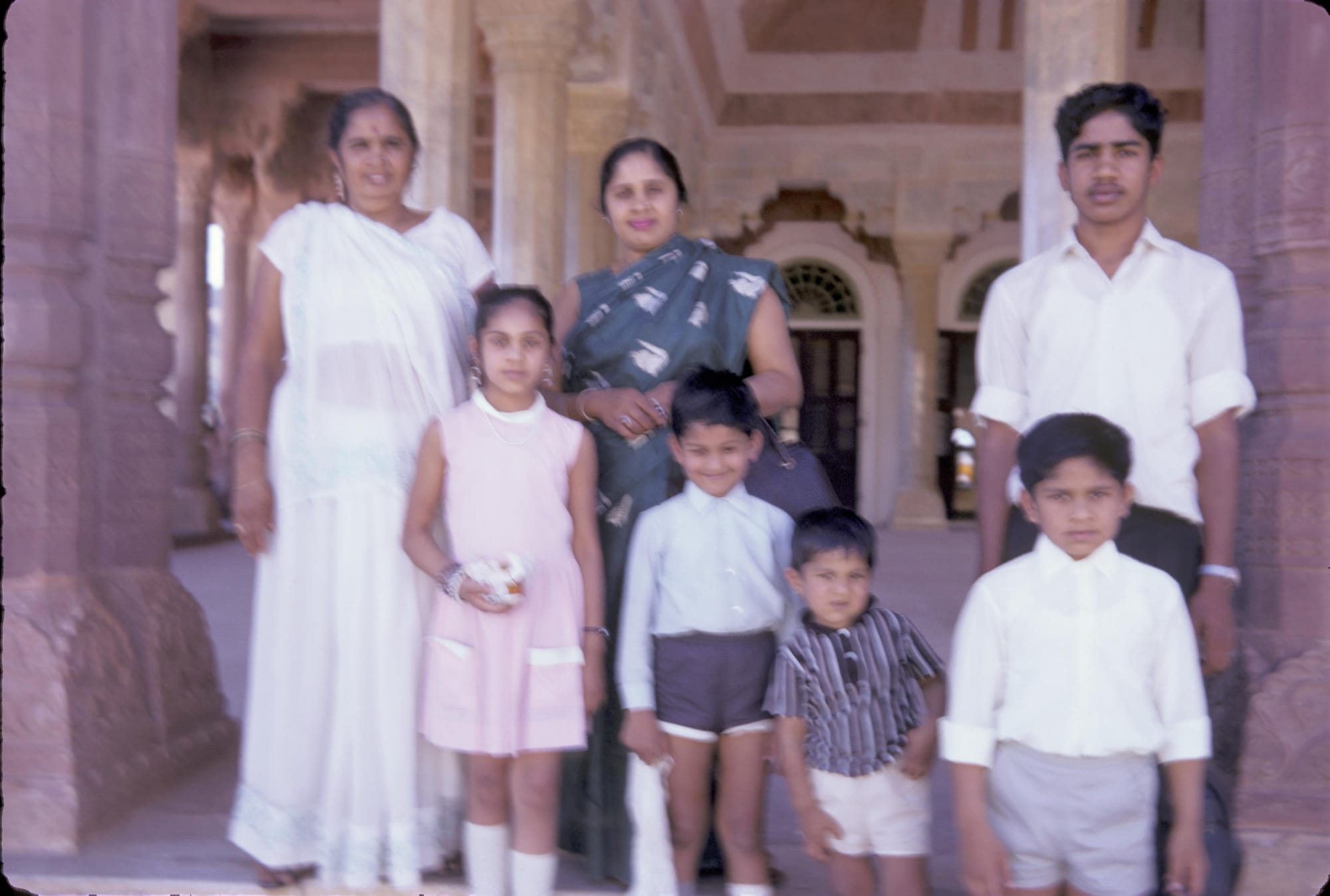 Mataji and her children and Rajmamaji and her sister. Location unknown, a sandstone palace or temple
