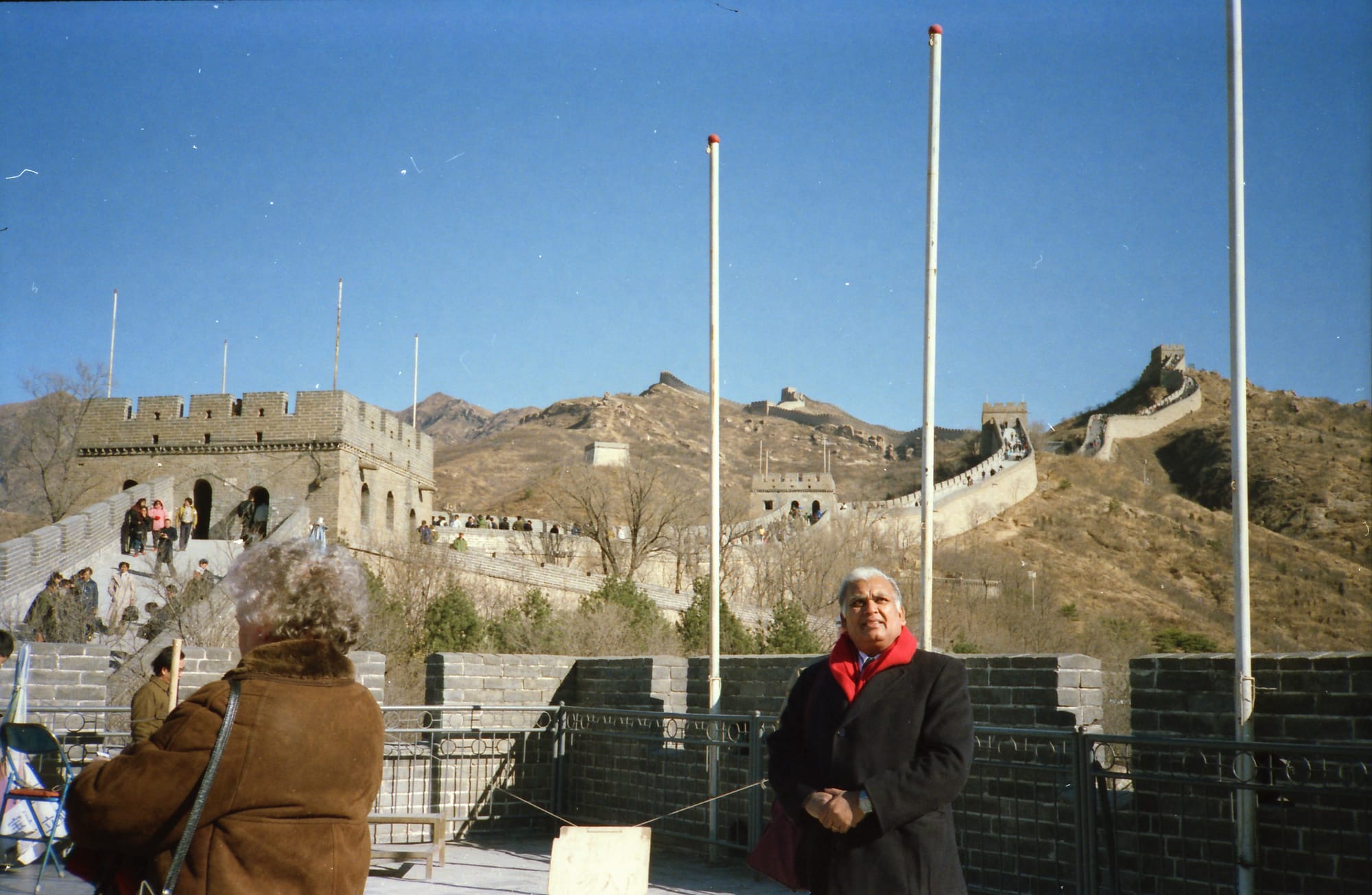 Papaji in a red scarf, and a second person at the left with their back to the camera. The Great Wall of China, at Badaling