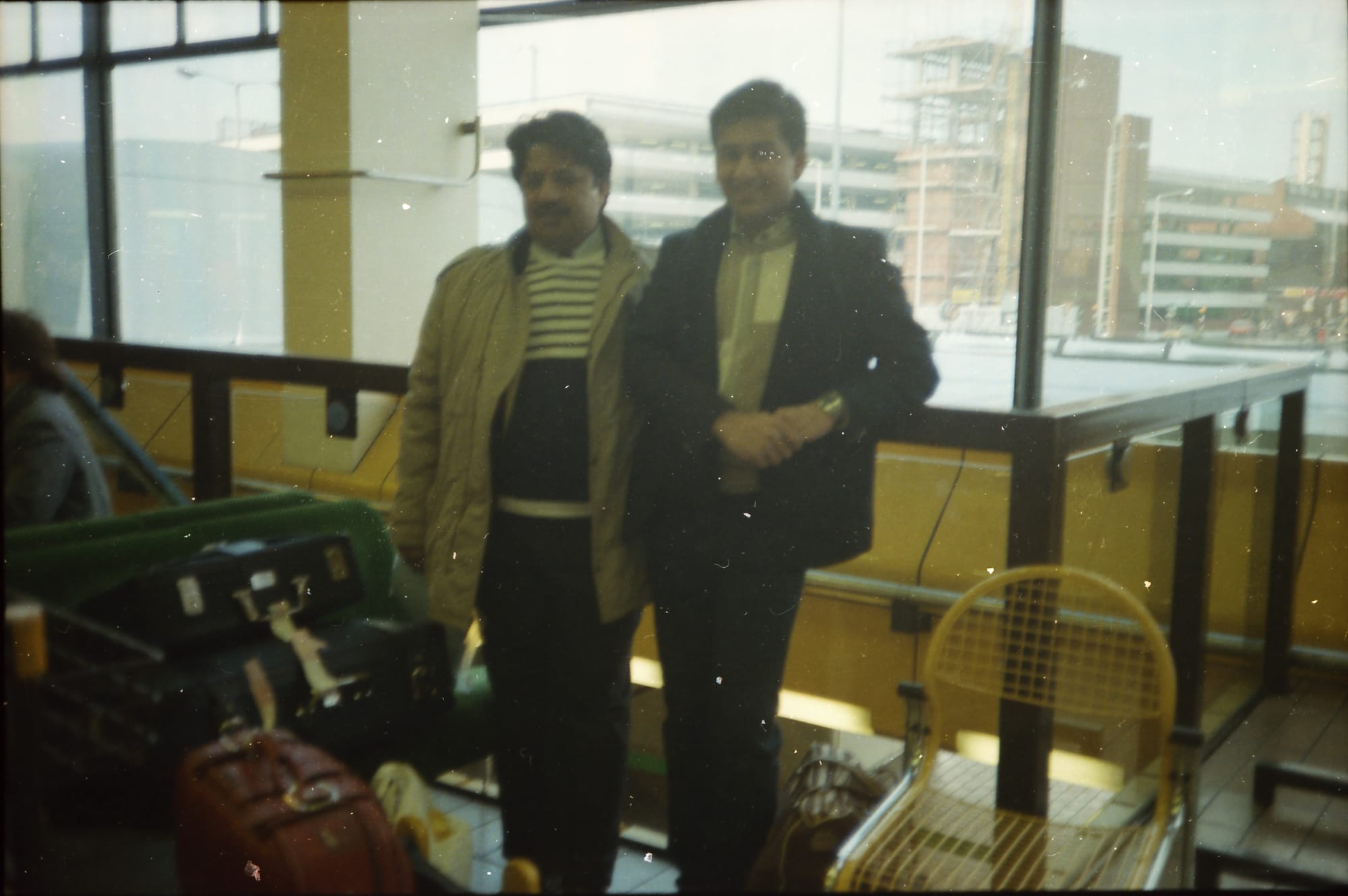 Sunil and a friend. An airport terminal, location unknown