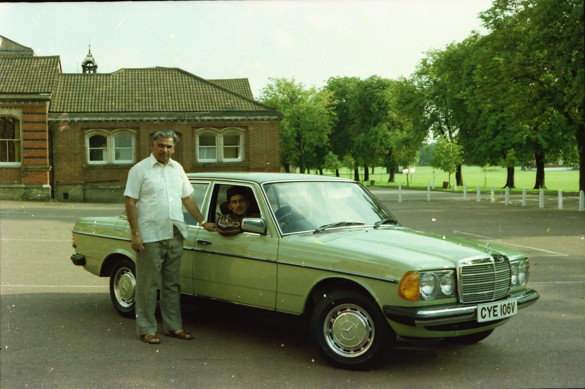 Man and boy at a Mercedes W123. Dulwich College, London