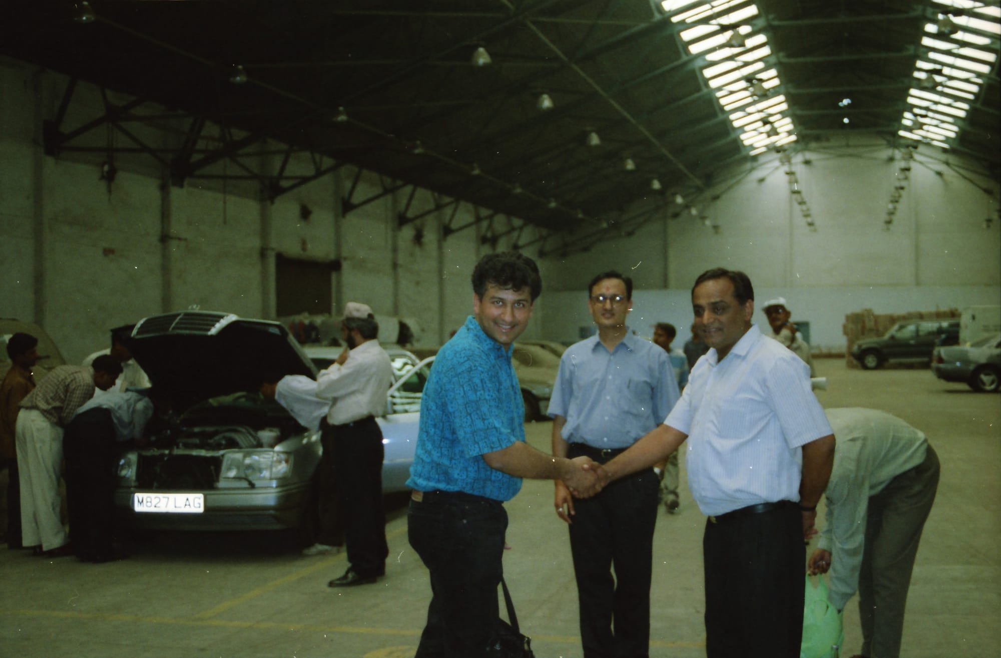 Handshake over a Mercedes. A warehouse in the Gulf