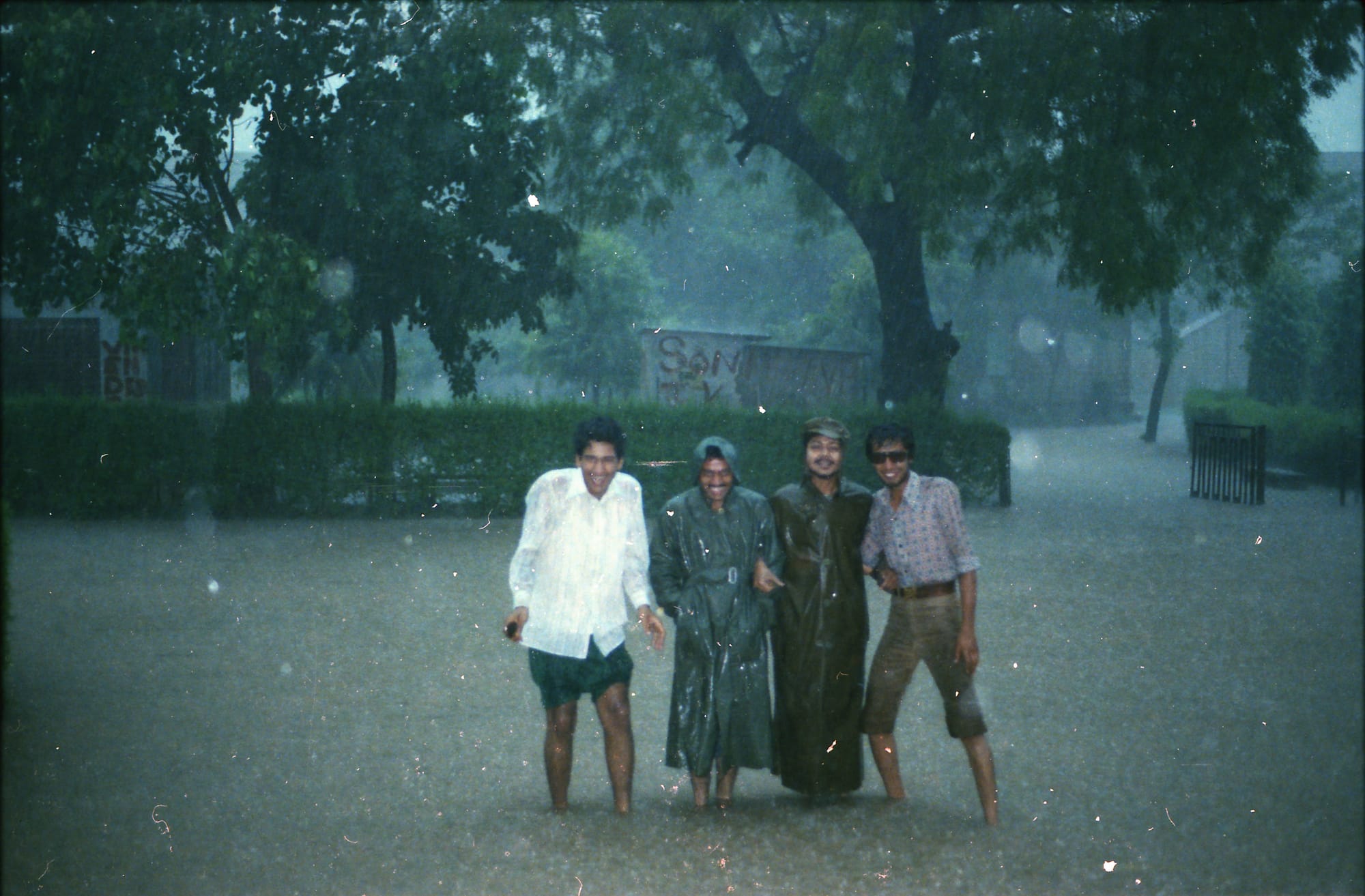 Sunil and three friends in floodwater. India, a monsoon flood, probably Jaipur