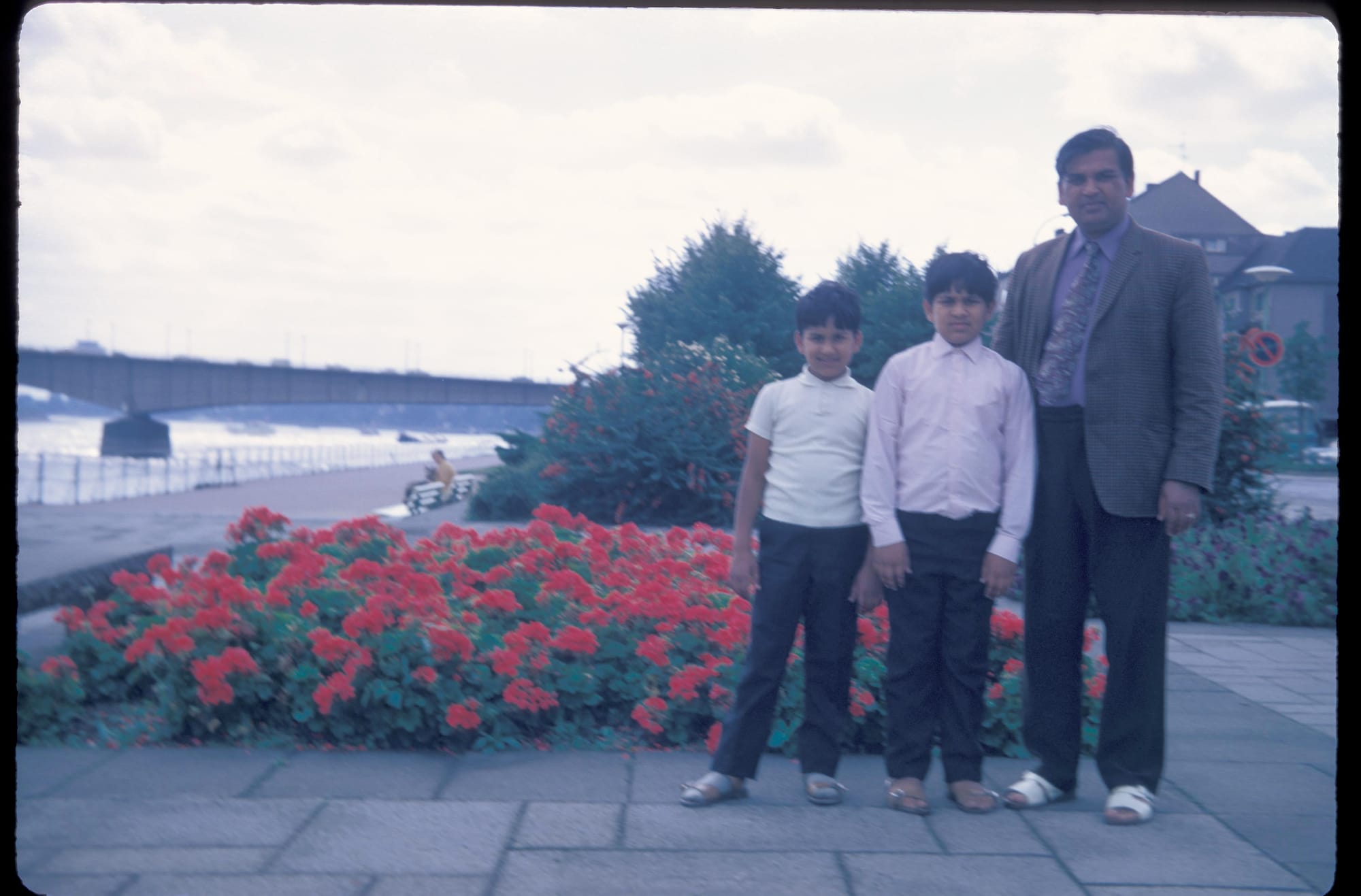 Papaji, Anil and Sunil, by a river. A European riverside, possibly Germany