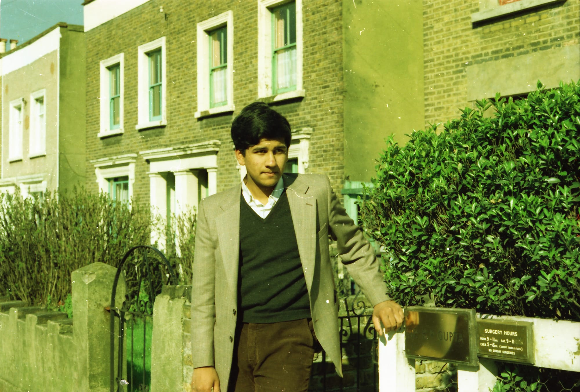 Sunil as a teenager, hand resting on his father's brass plate. The surgery is Papaji's. Crystal Palace Road, East Dulwich