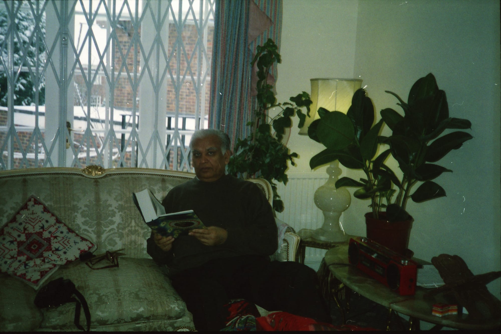 Papaji reading, snow outside. A London terrace